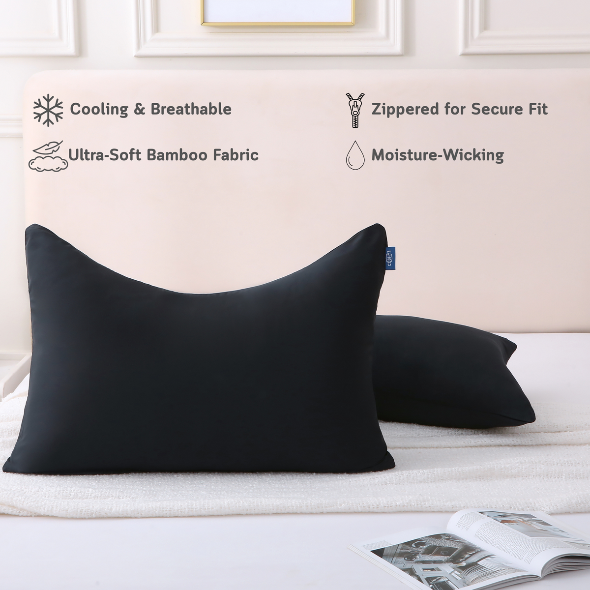 Two curved black Cushyz bamboo cooling pillow covers on pillows in a minimalist bedroom setting, labeled with features: cooling and breathable, ultra-soft bamboo fabric, hidden zipper for secure fit, and moisture wicking.