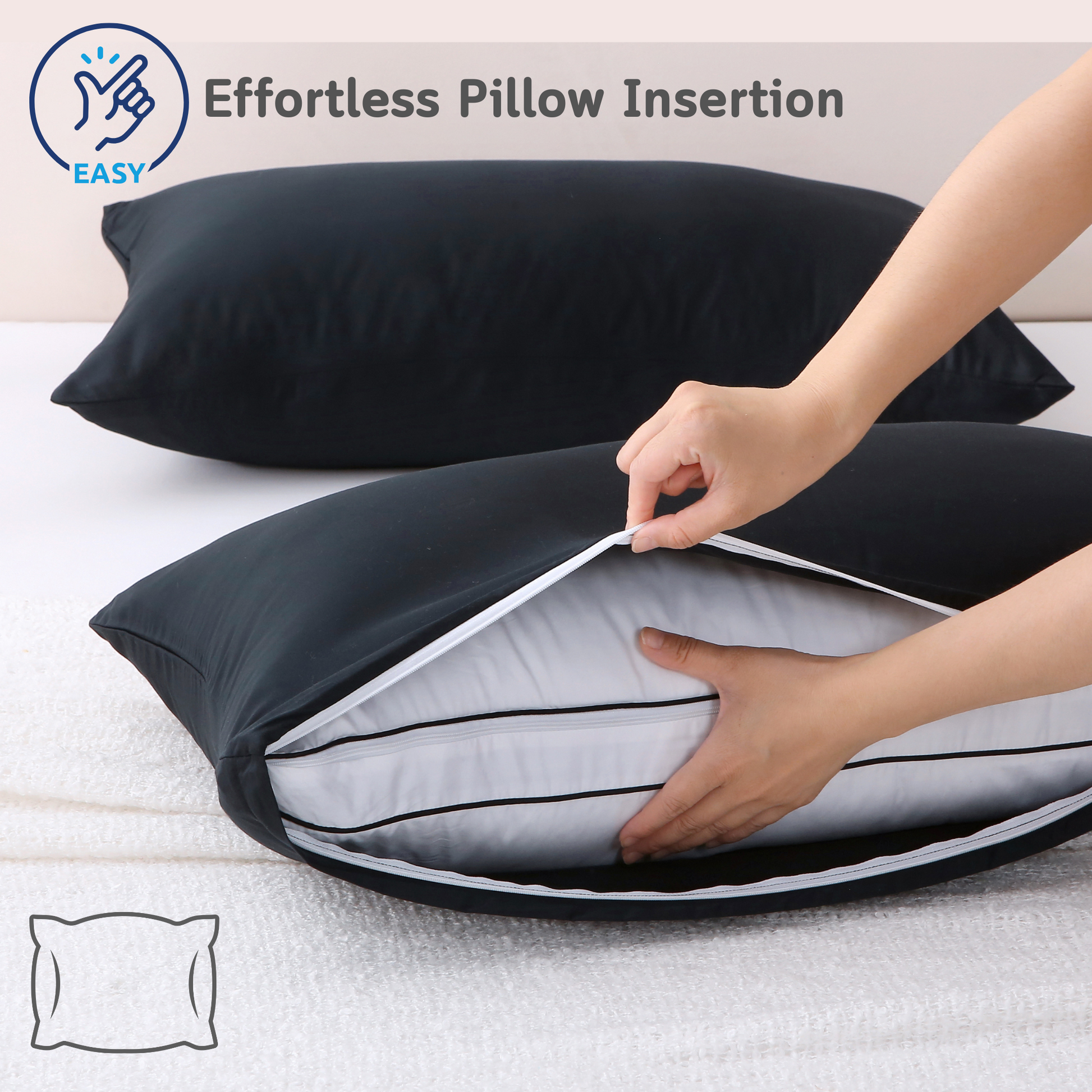 Person inserting a pillow into a black Cushyz bamboo cooling pillow cover on a bed, featuring a wide side opening for effortless pillow insertion and secure fit, labeled “EASY”.