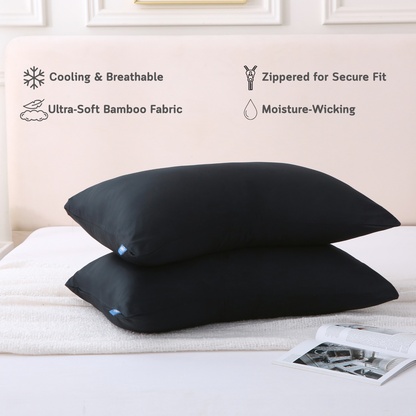 Two black Cushyz bamboo cooling pillow covers on pillows in a minimalist bedroom setting, labeled with features: cooling and breathable, ultra-soft bamboo fabric, hidden zipper for secure fit, and moisture wicking.