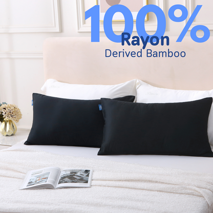Two black Cushyz bamboo cooling pillow covers neatly placed on a bed, labeled “100% rayon derived from bamboo”.