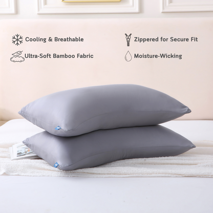 Two gray Cushyz bamboo cooling pillow covers on pillows in a minimalist bedroom setting, labeled with features: cooling and breathable, ultra-soft bamboo fabric, hidden zipper for secure fit, and moisture wicking.